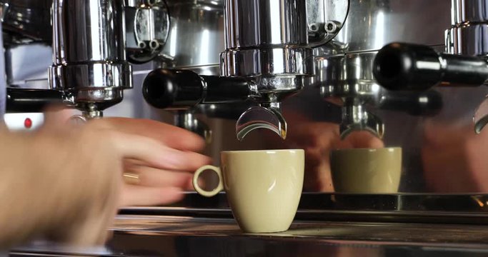 Close-up of vintage barista making an espresso on an authentic Italian coffee machine.