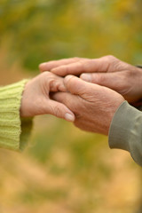 Portrait of couple holding hands, close up