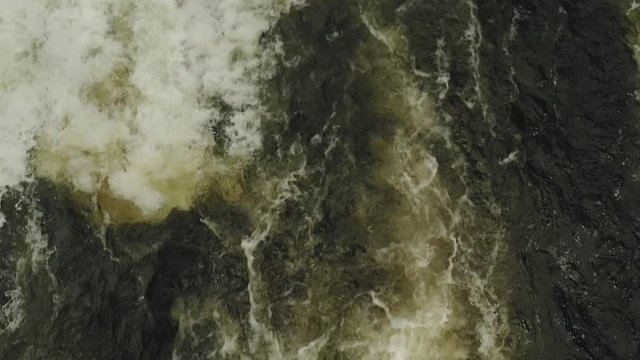 Aerial fast flowing water over rapids immersive close up 