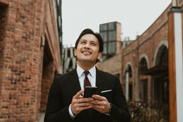 Businessman in the city texting