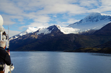 Passengers enjoy the breathtaking panoramic landscape scenery with mountains and glaciers inside...
