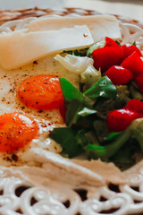 breakfast with fried eggs, fresh vegetables, cheese,bread and coffee