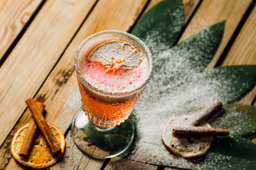 orange rum cocktail and spritz aperol with airy foam and orange chips on a wooden background with...