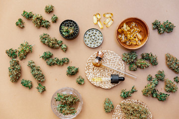 Obraz na płótnie Canvas Medical marijuana buds with oil and glass pipe. Top view, flat lay