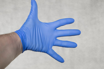 isolated gloved hand on a gray background