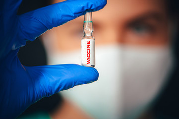 Coronavirus Covid-19 Protection and Vaccination. Closeup of portrait, doctor with a bottle of...