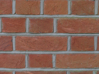 Obraz premium Brickwork background with old red bricks and grey mortar