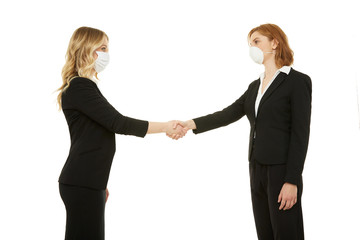 Businesswomen handshake with masks