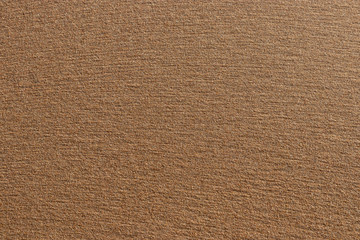Sunlit sand on the beach for background