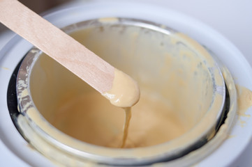 wax  and wooden stick on white background depilation remove hair
