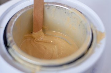 wax  and wooden stick on white background depilation remove hair