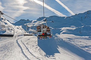 Ski resort chairlift going over a mountain