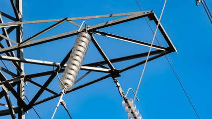 Electricity pylon insulator hanging from a towers crossbeam