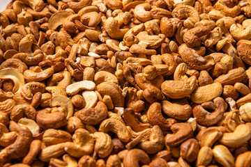 Delicious cashew nuts as background, top view. Many nuts
