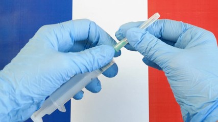 covid - 19, coronavirus concept. Hand in medical glove with pills on French flag, coronavirus epidemic in France concept	 - Powered by Adobe