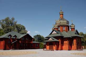 modern wooden church with golden domes