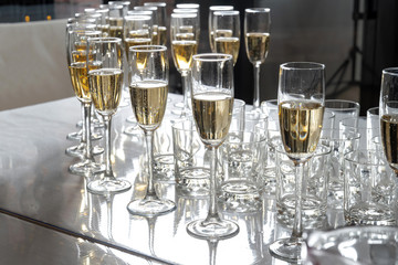 Row of glasses filled with champagne, a beautiful catering party-2.