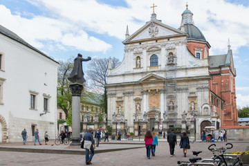 St. Peter and Paul Church with statues of saints on the Grodka Street in the Old Town of Krakow. A memorial of Jesuit priest Piotr Skargaon the St. Mary Magdalene Square.