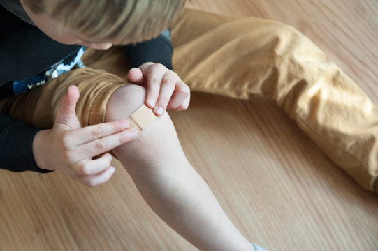 Boy With Band Aid On His Knee