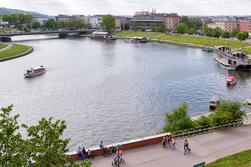 People walk along Vistula river in Krakow, Poland