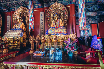 Naklejka premium Sculptures of Buddha in Harmony and Peace hall, part of famous Yonghe Temple in Beijing, China