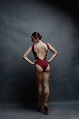 Fototapeta na wymiar Young beautiful ballet dancer is posing in studio