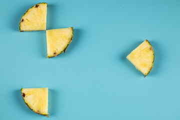 Fresh pineapple slices isolated on blue background 