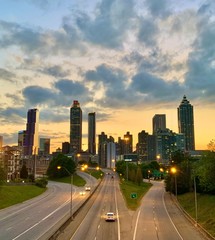 Downtown Atlanta skyline and highway with light traffic  during sunset  