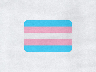 Transgender flag on a grey paper background