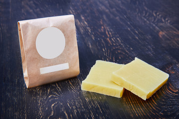 Natural handmade soap bars on wooden background. Spa organic soap in eco paper packaging.