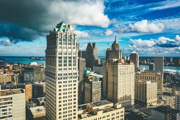 Cityscape of Detroit under the sunlight and a dark cloudy sky at daytime in Michigan in the US