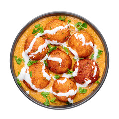 Malai Kofta Curry in black bowl isolated on white background. Malai Kofta is indian cuisine dish with potato and paneer cheese deep fried balls in onion tomato gravy with spices. Indian Food.