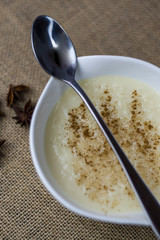 bowl of rice pudding and cinnamon