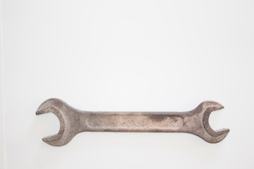 Old rusty wrench on a white and metal background. several wrenches of different sizes. Card with copy space for text