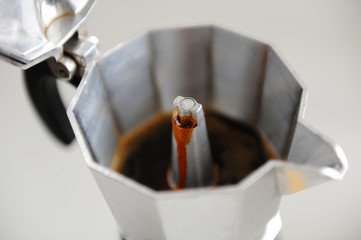 Coffee brewing in Italian moka pot close up