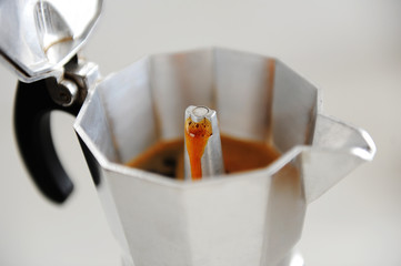 Coffee brewing in Italian moka pot close up