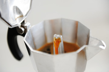 Coffee brewing in Italian moka pot close up