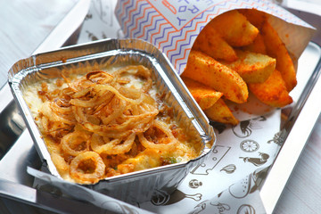 baked cod in cream with onion fries and fried potatoes