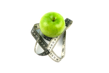 A green apple and a black and white measuring tape are all about proper nutrition.