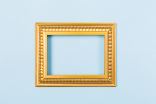 Golden frame empty blank picture on light blue background . Copy space free space for text. Holiday card concept. Mock up. Greeting. Mother's Day. St Valentine's Day. Love .