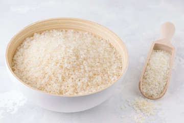Fototapeta na wymiar uncooked rice on a gray concrete background