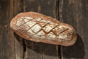 Fototapeta na wymiar Fresh baked bread at wooden table