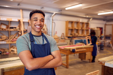 Portrait Of Male Student Studying For Carpentry Apprenticeship At College