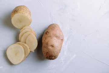 Sliced potato slices on a cutting kitchen board