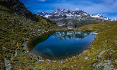Beautiful blue lake in the mountains, reflection of mountains in the lake