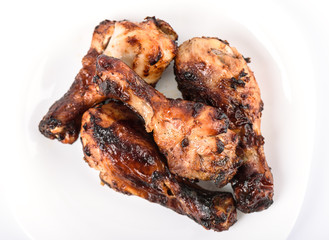Top view. Juicy grilled chicken drumsticks marinated in soy sauce.