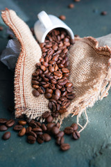 
Cup and coffee beans arranged on burlap sack

