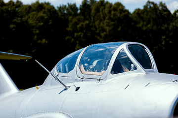 cockpit of an old silver Russian fighter jet 