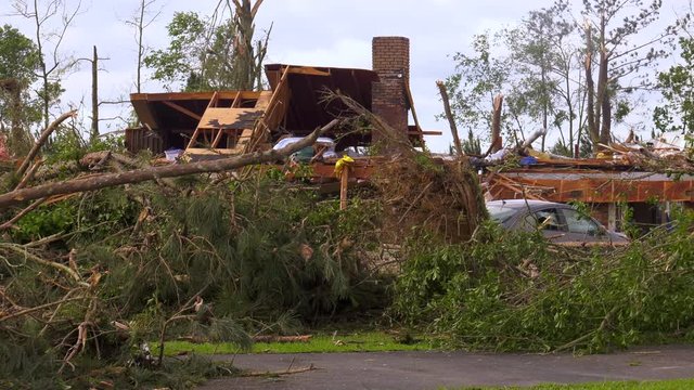 Tornado structural damage to house after an EF-4 tornado rips through a small Mississippi town. Severe weather aftermath from damaging winds.