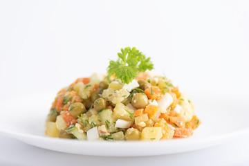 Selective focus. Dietary vitamin salad of boiled carrots, potatoes, eggs and canned green peas.